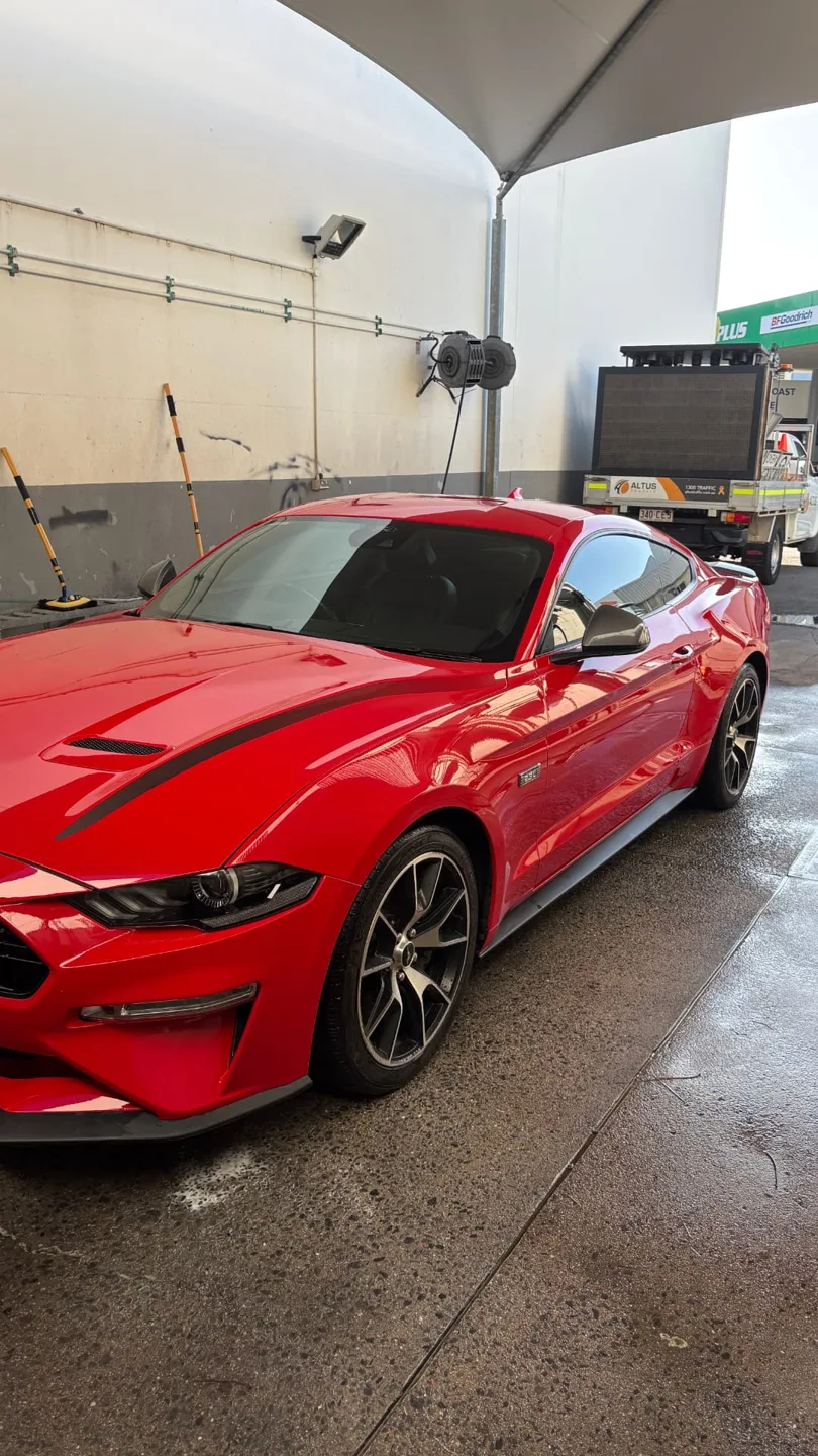 Red Ford Mustang freshly detailed under a Sunshine Coast carport
